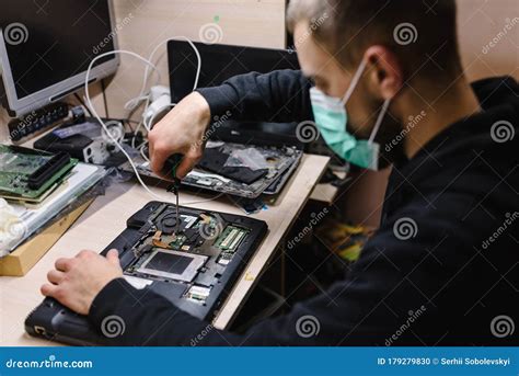 Computer Technician Working on a Laptop