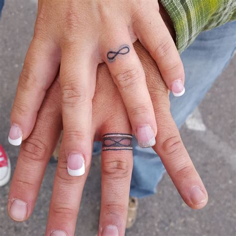 Ring finger tattoo of heartbeats for happily married
