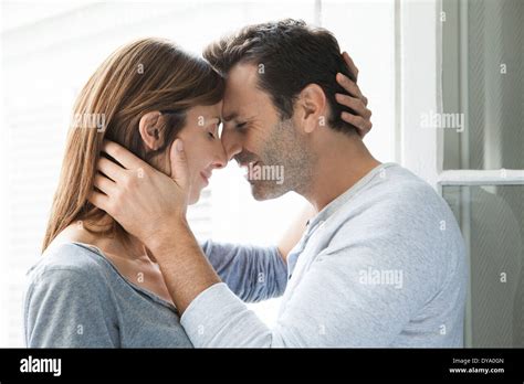 Couple Cuddling by Window