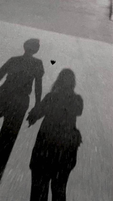 A couple in silhouette with a dramatic black shadow.