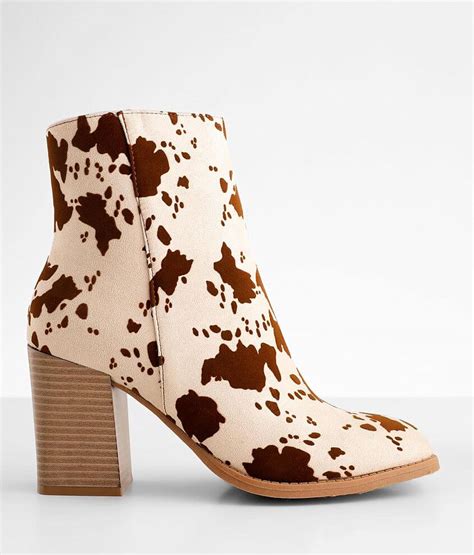 Step up your style with trendy cow print ankle boots