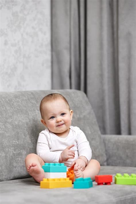 Infant playing with colorful toys