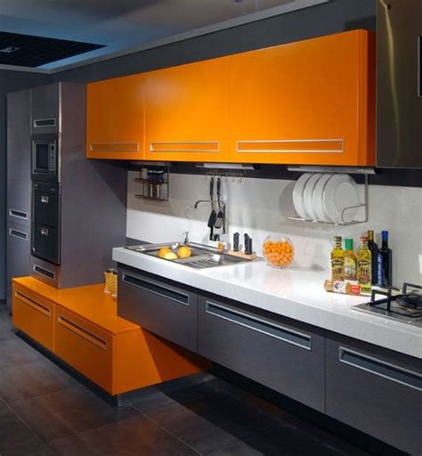 modern kitchen in orange and gray back wall in brick look brick 