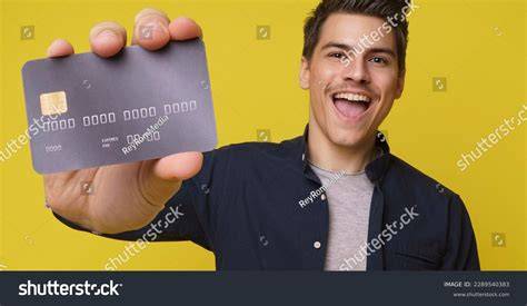 Person holding a credit card happily