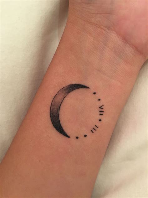 Crescent moon by Kevin Jenkins tattooed on a wrist