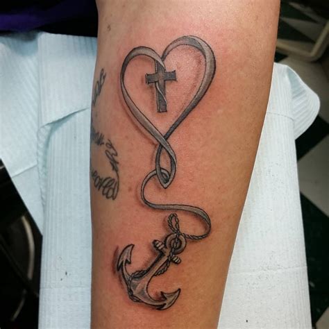 anchor cross heart tattoo with flying birds on wrist