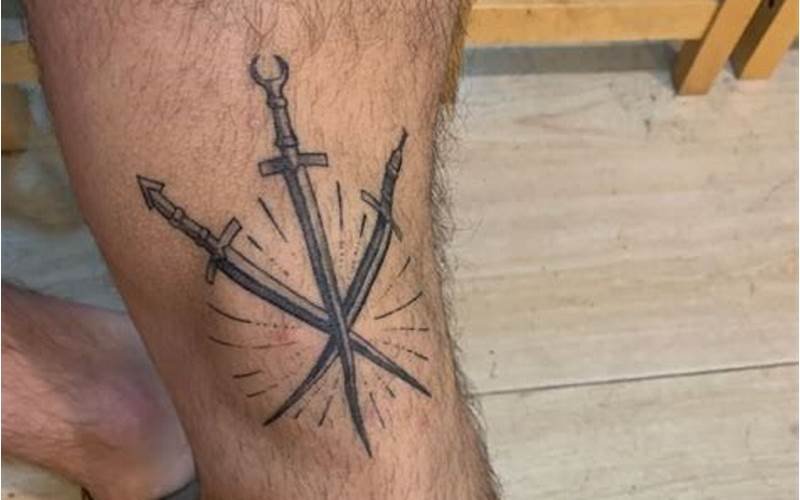 Crossed Swords Tattoo Above Knee