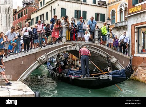Crowded Venice canal during peak tourist season