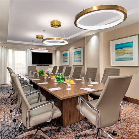 Crowne Plaza Toronto Airport meeting room with long conference table and plush chairs