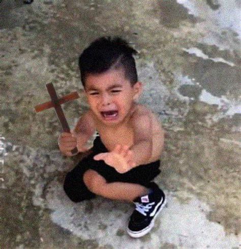 Crying Kid Holding Cross