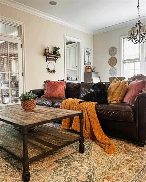A dark brown sofa with pops of color in a transitional style living room.