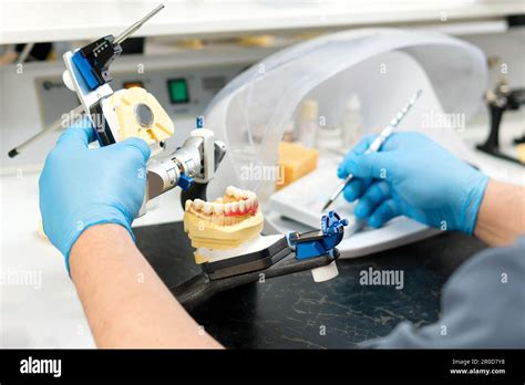 Dentist fixing dentures in a lab
