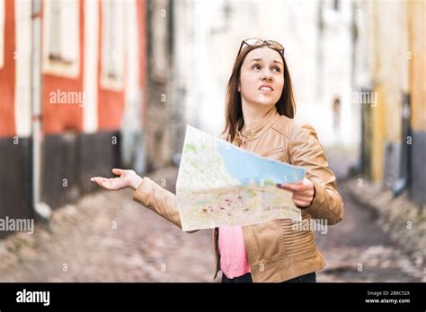 Disappointed Tourist Looking at Map