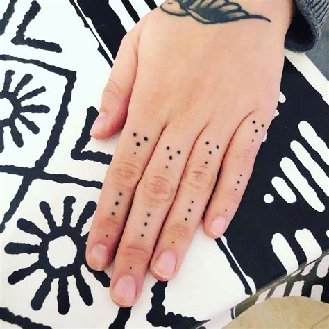 Artist Celebrates Change with EyeCatching Red Dot Tattoo