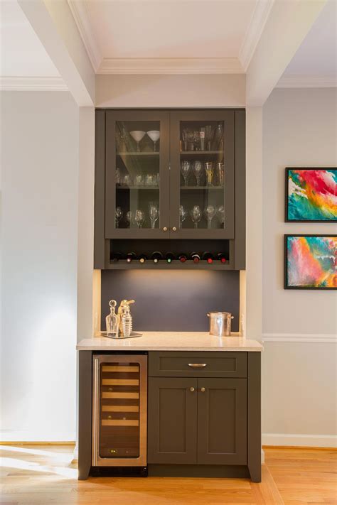 The new custom builtin dry bar with wine storage acts as a focal point for an existing entry