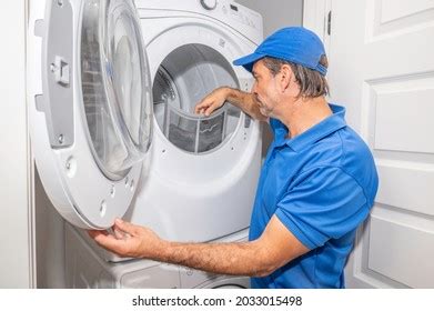 Dryer Repair Technician Checking Dryer