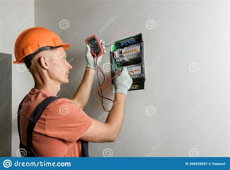 Electrician Checking Circuit Breaker