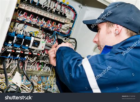 Electrician Working on Panel