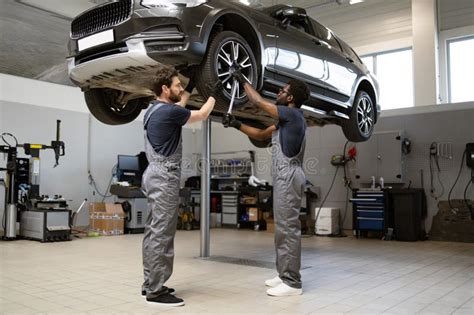 Expert Technicians Working on a Car