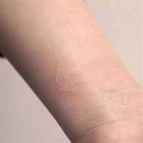 The Enigmatic Beauty of Faded White Ink Tattoos: A Mesmerizing and Mysterious Trend