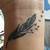 Feather On Wrist Tattoo