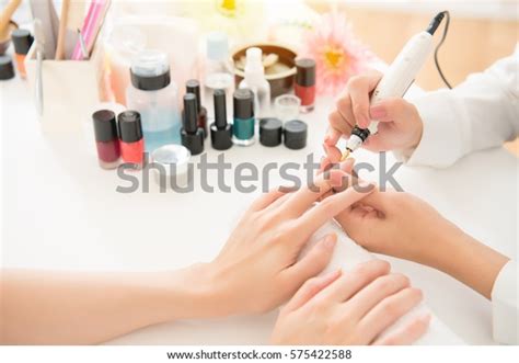 Female Asian Salon Manicurist Using