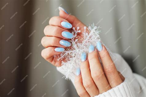 Female Hand Winter Manicure Snowflakes