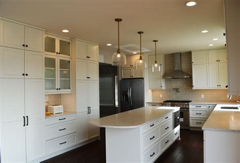Kitchen from floor to ceiling in a light cream glossy finish with high end pull out