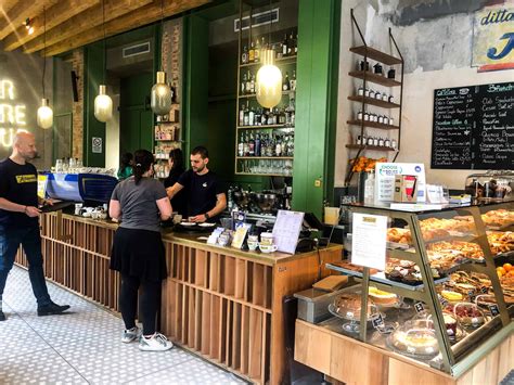 Interior of a classic coffee shop in Florence with people enjoying coffee and pastries.
