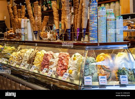 A picturesque scene of a gelato shop in Florence, Italy, featuring brightly colored gelato flavors