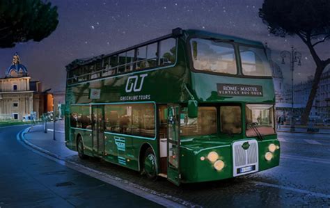 A bus driving through Florence at night, with the Ponte Vecchio bridge illuminated by warm lights.