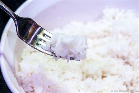 Fluffing the rice with a fork