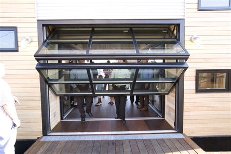 Hydraulic bifold glass garage door by Crown Inc. Glass garage door, Garage doors, Folding