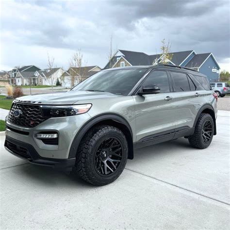 Ford Explorer driving slowly on a moderate dirt trail with a clear path ahead