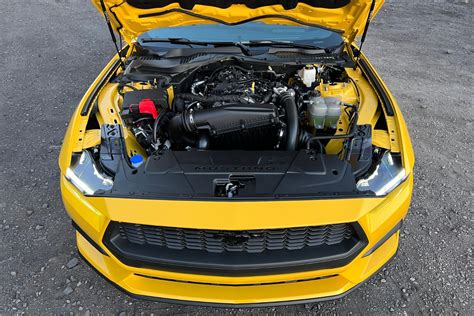 Mechanic performing engine tuning on a Ford Mustang