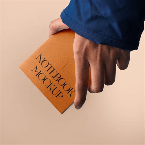 Download Free Notebook in a Hand Mockup PSD Generator