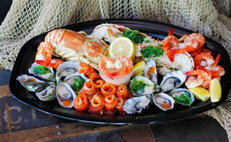 Seafood platter with fresh lobster, oysters, charred lime prawns and