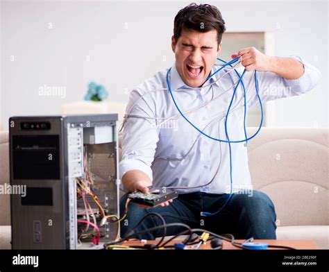 Frustrated person working on a broken computer