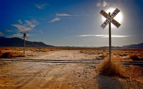 Get The Sign For A Railroad Crossing Is A Background