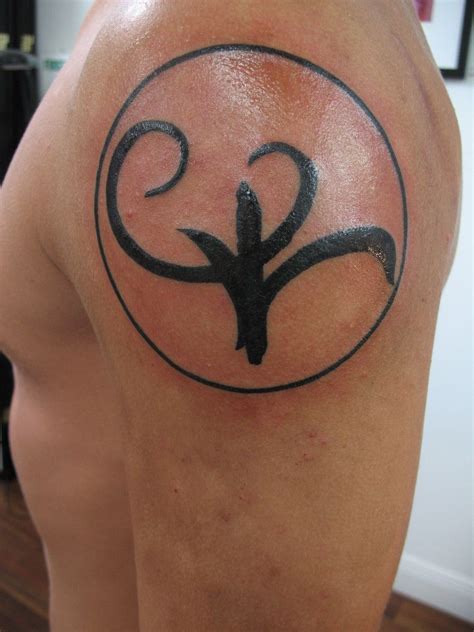 The tattoo I designed. The circle with the arrows is the