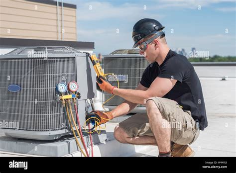 HVAC technician inspecting unit