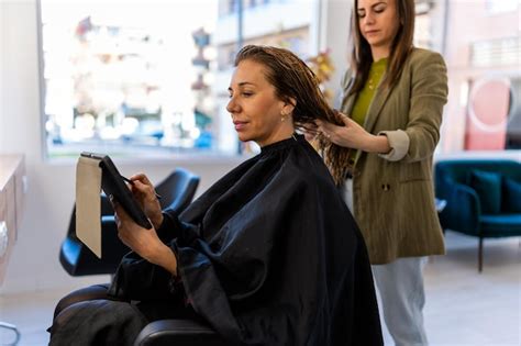 A client using a tablet to book an appointment at a hair salon
