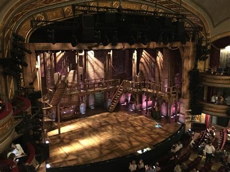An image showing a scene from the musical Hamilton performed on Broadway, featuring actors, costumes, and elaborate set designs. 