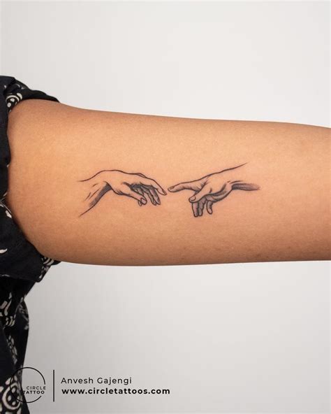 Hand Touching Tattoo