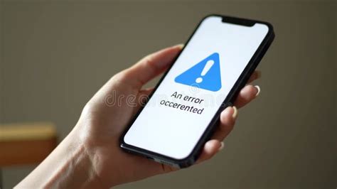 Hand holding a smartphone with website error message
