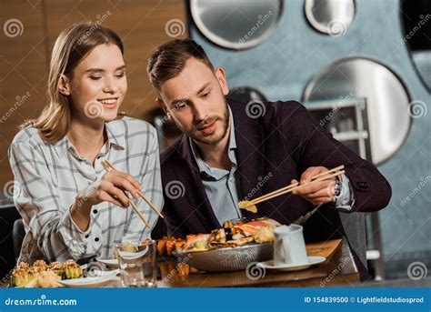 Happy Couple Eating Sushi