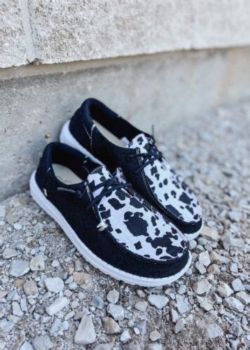 Step up your style with Hey Dude's Women's Cow Print shoes