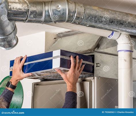 Homeowner Checking Their Furnace Filter
