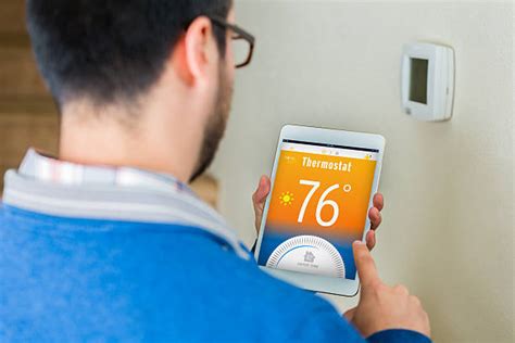 Homeowner Checking Thermostat