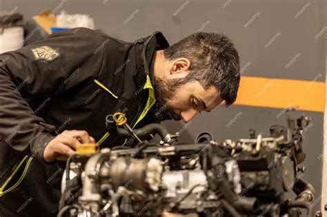 Hybrid Vehicle Technician Inspecting Engine